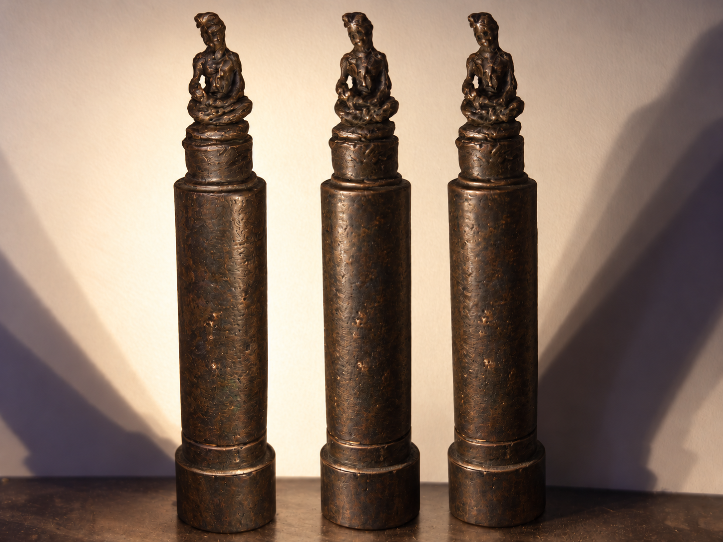 Small bronze Buddha sculpture inspired by a figure carved directly into lipstick in Japan in 1996.