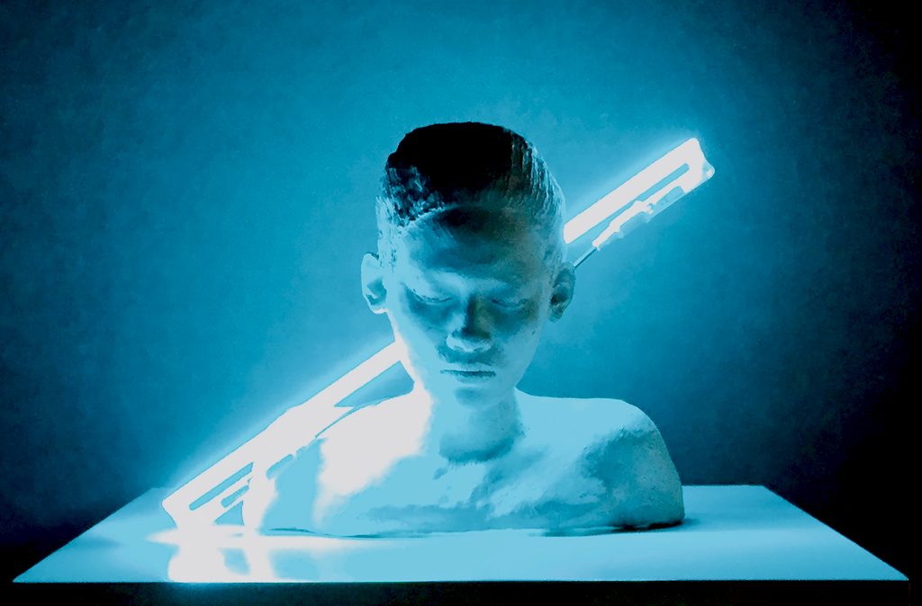 Introspection, 2015: ceramic bust with closed eyes and bowed head, lit by a diagonal blue neon tube.