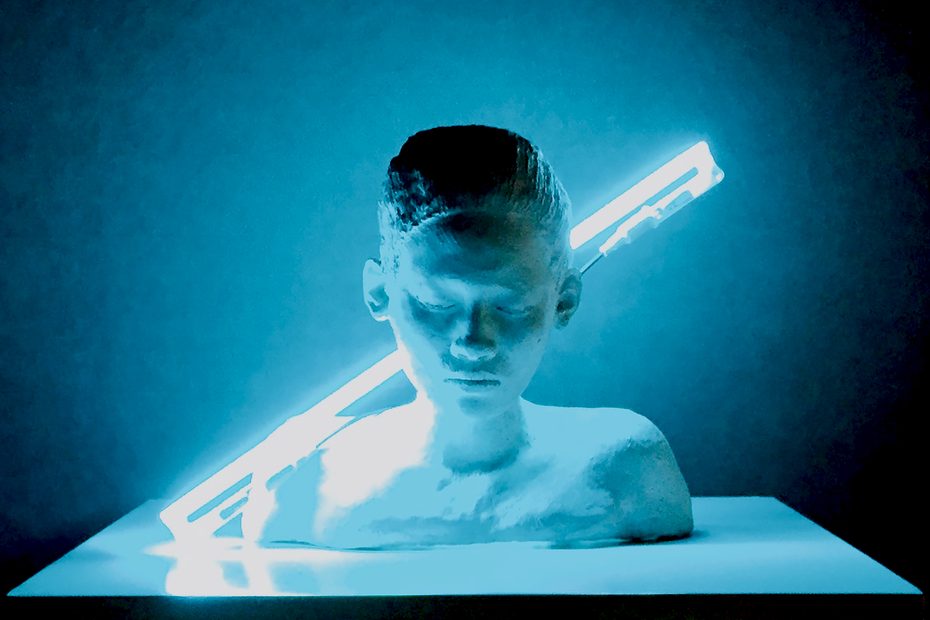 Introspection, 2015: ceramic bust with closed eyes and bowed head, lit by a diagonal blue neon tube.